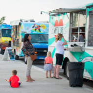 People standing in line at a food truck at Crane Plaza in Herriman