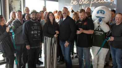People applauding as a ribbon is cut to celebrate the opening of a new business in Herriman