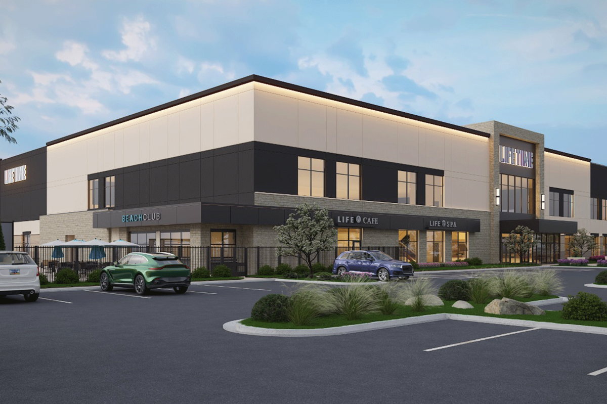 Rendering of the planned Life Time Fitness facility in Herriman, showing a two-story modern building with large windows, stone and stucco exterior, and signage for Life Time, LifeCafe, and LifeSpa. The foreground includes landscaping, a small parking lot, and parked vehicles.