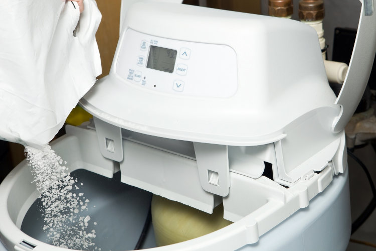 Photo of salt being poured into a water softener